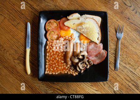 Full English breakfast / Fry up on a square black plate Stock Photo