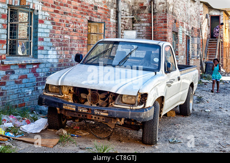 A battered van stands outside the flat dwellings of residents of Langa African Township near Cape Town, South Africa Stock Photo