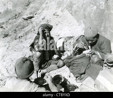 Indigenous workers eating while building the Burma road during WWII rice Asia CBI theatre theater China India Stock Photo