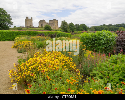 Helmsley Castle overlooking the Helmsley Walled Garden with a show of summer flowers Stock Photo