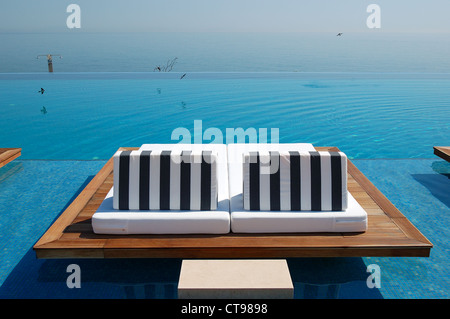 Infinity swimming pool by beach at the modern luxury hotel, Pieria, Greece Stock Photo