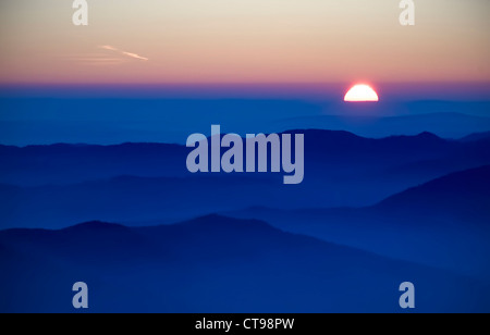 mystic sunset with fog and mountains in Romania Carpathians Stock Photo