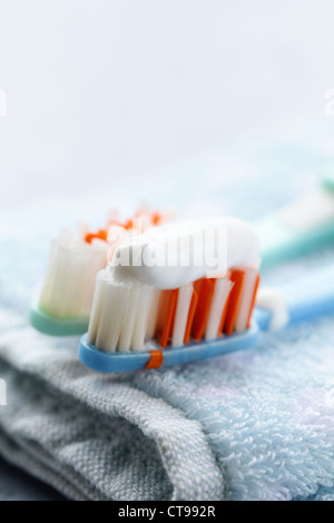 Couple toothbrushes  with toothpaste on a towel Stock Photo