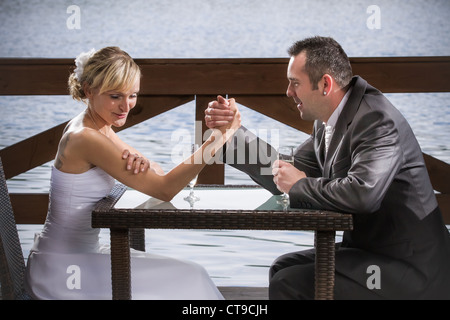 The bride wrestle on the hand of the groom Stock Photo