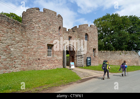 Walkers outside Beeston Castle UK roadside gatehouse & entrance to English Heritage ticket office giving access to castle ruins atop 500ft high crag Stock Photo