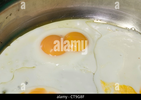 A twin yoke egg in a frying pan. Stock Photo