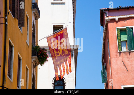 Flag of the Most Serene Republic of Venice on urban house in Venice, Italy Stock Photo