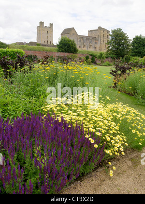 Helmsley Castle overlooking the Helmsley Walled Garden with a show of summer flowers Stock Photo