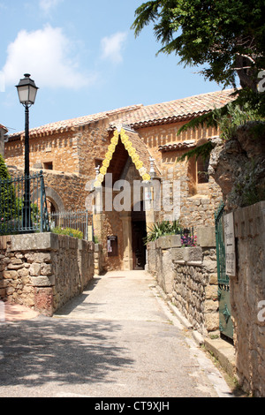 The path to the entrance of the Church of Saint Mary Magdalene Rennes le Chateau Aude France Stock Photo