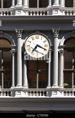 detail view classical cast iron facade E V Haughwout building with Corinthian style columns & restored old clock Broadway Soho Stock Photo