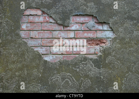 Crumbling plaster on a brick wall Stock Photo
