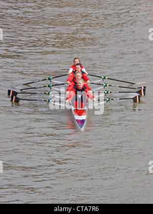 A young female coxless crew competing in a river race in Bristol UK Stock Photo