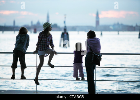 Family at the pier in Lido di Venezia, View towards Venice, Veneto, Italy