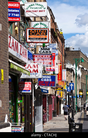 Signs Above Shops, Take Aways & Mini-cab Offices on Brick Lane in London's East End Stock Photo