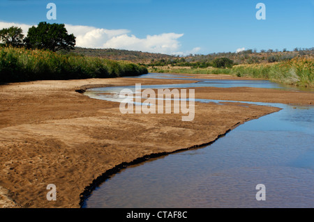 The Black Umfolozi River flowing through the Hluhluwe-Umfolozi Game Reserve in Kwazulu Natal, South Africa Stock Photo