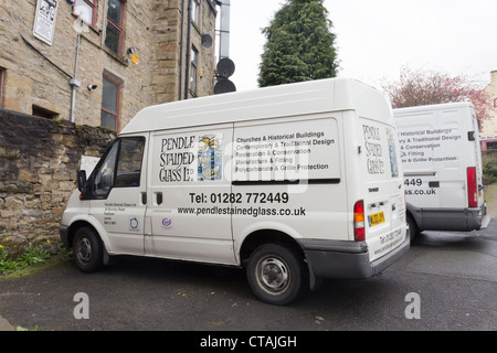 Ford Transit vans belonging to Pendle Stained Glass Limited parked at the rear of their works on in Padiham, Lancashire. Stock Photo