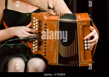 Lorraine playing the accordian with 'Púca' a traditional Irish music band group playing at the Arlington Hotel, Dublin. Stock Photo