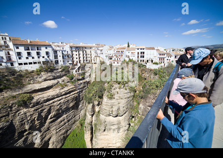 People on vantage point admiring Old Town of Ronda historic architecture, traditional Pueblo Blanco in Andalusia, Spain. Stock Photo