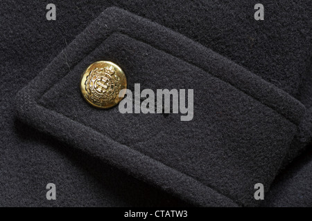 decorative gold coloured regiment button on Beechers Brook black woolen coat Stock Photo