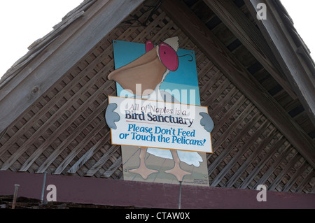 Bird sanctuary and pelican protection sign at the Naples, Florida Municipal Fishing Pier in the Gulf of Mexico Stock Photo