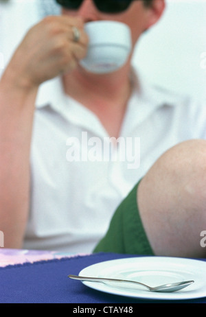 A man having coffee at a cafe on the island of Lipari in Sicily, Italy Stock Photo