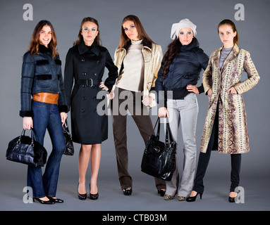 Five girls in different clothes, autumn winter collection clothes Stock Photo