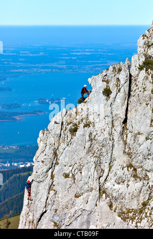 Mountaineers at Staffelstein, Kampenwand, lake Chiemsee in background, Chiemgau, Upper Bavaria, Germany Stock Photo