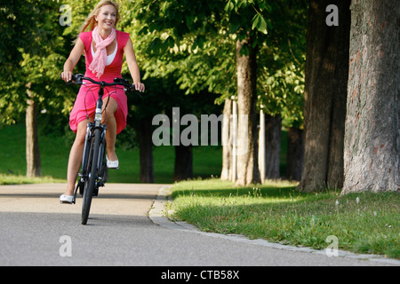 Woman cycling through Rosenstein Park, bike tour, Rosenstein Park, Stuttgart, Baden-Wurttemberg, Germany Stock Photo