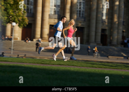 Young couple jogging, Upper Castle Gardena, Staatstheater, State Theater, Stuttgart, Baden Wurttemberg, Germany Stock Photo
