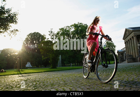 Woman cycling through Rosenstein Park on an E-Bike, bike tour, e-bike, Rosenstein Park, Stuttgart, Baden-Wurttemberg, Germany Stock Photo