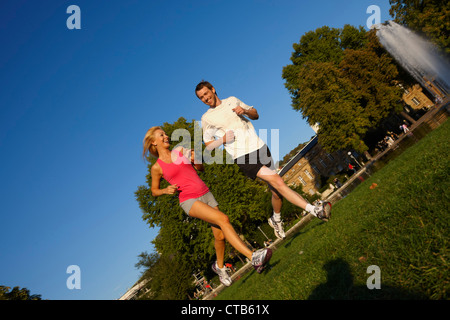 Young couple jogging, Upper Castle Gardens, Staatstheater, State Theater, Stuttgart, Baden Wurttemberg, Germany Stock Photo