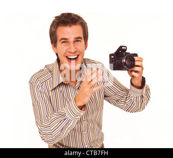 Young good looking white man with a digital camera, showing various emotions Stock Photo