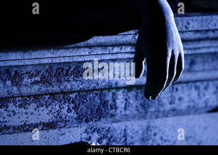 Detail of the hand of a fallen angel sculpture above a tomb in a Southern US Cemetery Stock Photo