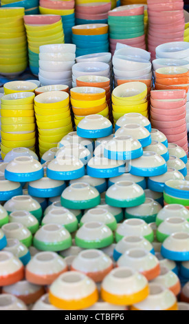 Inexpensive dishware of different colors on the eastern market Stock Photo