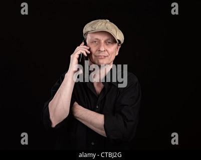 Guy using a mobile phone with copyspace on black Stock Photo