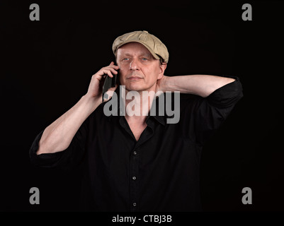Guy using a mobile phone with copyspace on black Stock Photo