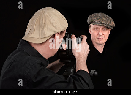 Portrait Photographer with camera on black Stock Photo
