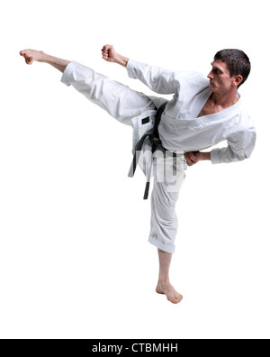 Karate. Man in a kimono hits foot on the white background Stock Photo