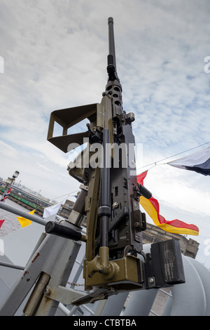 machine gun on warship against dark sky Stock Photo