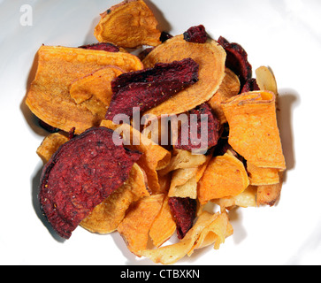 Vegetable crisps made with parsnip sweet potato carrot and beetroot. Stock Photo
