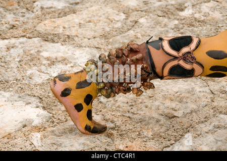 A Maya sacred animal actor/dancer in Jaguar dress with leg decorations at the Riviera Maya's Xcaret Park in Mexico. Stock Photo