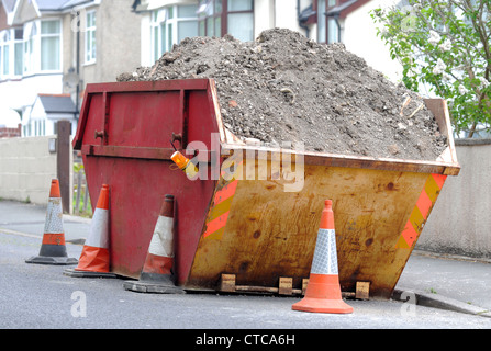 Skip, rubbish skip on residential street, Britain, UK Stock Photo