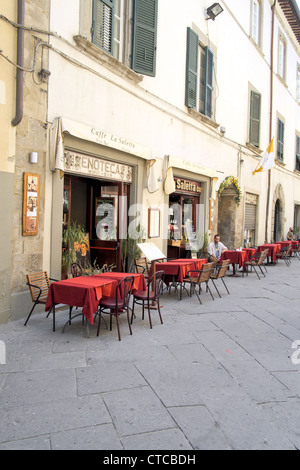 Man sat at a table outside of an Italian cafe restaurant in Cortona Italy Stock Photo