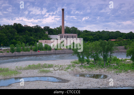 power plant and smokestack on banks of mississippi river below lock and dam number one in highland park minnesota Stock Photo