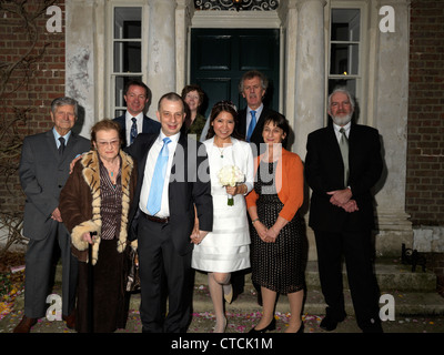 Bride And Groom With Family Outside Merton Registry Office In Morden Park House England Stock Photo