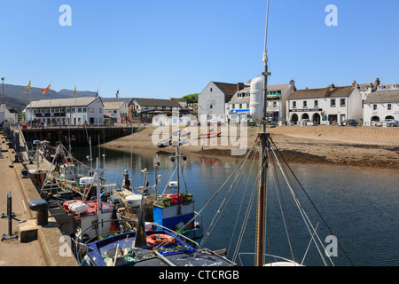 Fishing boats moored by quay in harbour on Loch Broom on north west highlands coast in Ullapool Wester Ross Highland Scotland UK Stock Photo