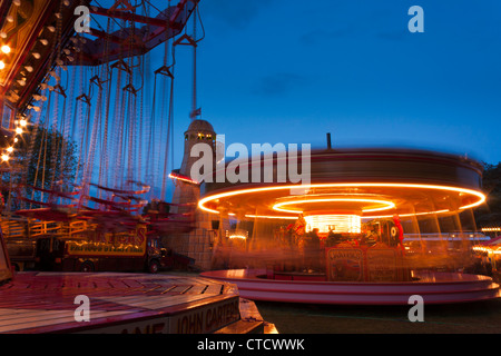 A traditional steam driven Merry-go-round and a Chair-o-Plane at the Carter's Steam Fair, England. Stock Photo