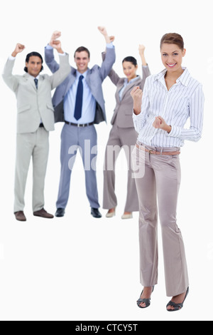 Secretary smiling and clenching her fists with very enthusiastic business people Stock Photo