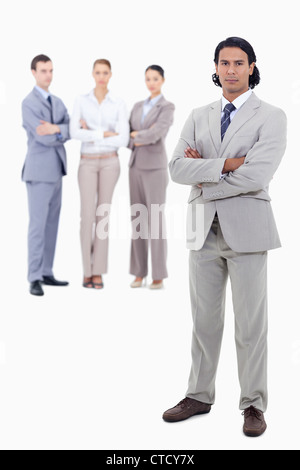 Businessman crossing his arms with serious people in background Stock Photo