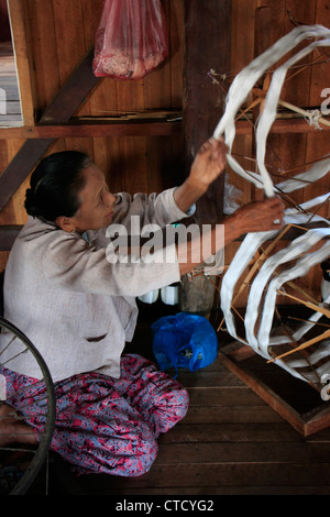 Burmese woman weaving lotus plant threads, Inle lake, Shan state, Myanmar, Southeast Asia Stock Photo
